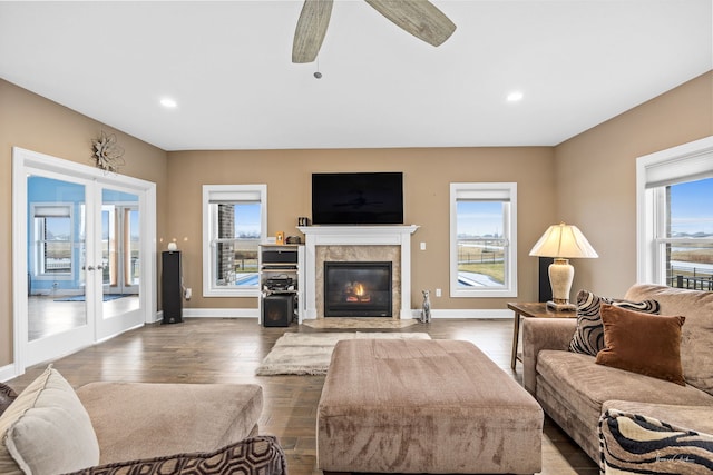 living room with french doors, ceiling fan, and dark hardwood / wood-style flooring