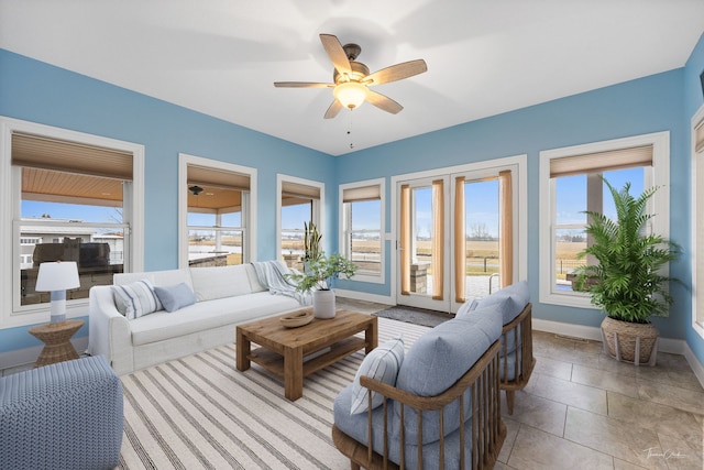 living room featuring ceiling fan and light tile patterned floors