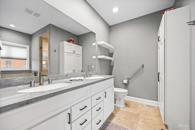 bathroom featuring vanity and toilet