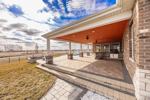 view of patio featuring ceiling fan and exterior kitchen