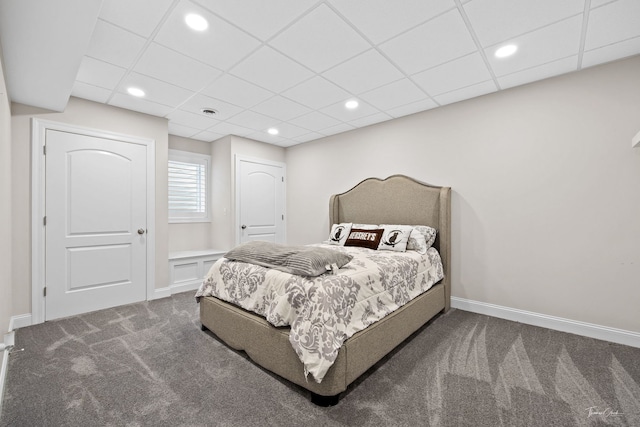 carpeted bedroom with a paneled ceiling