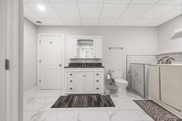 bathroom with vanity, a paneled ceiling, and toilet