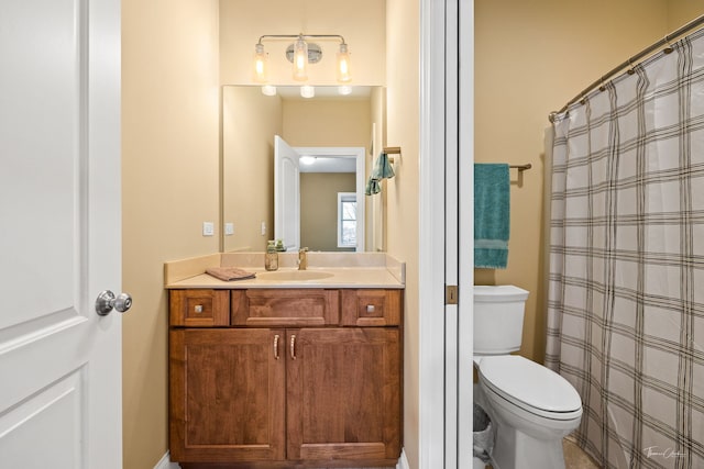 bathroom with vanity, walk in shower, and toilet