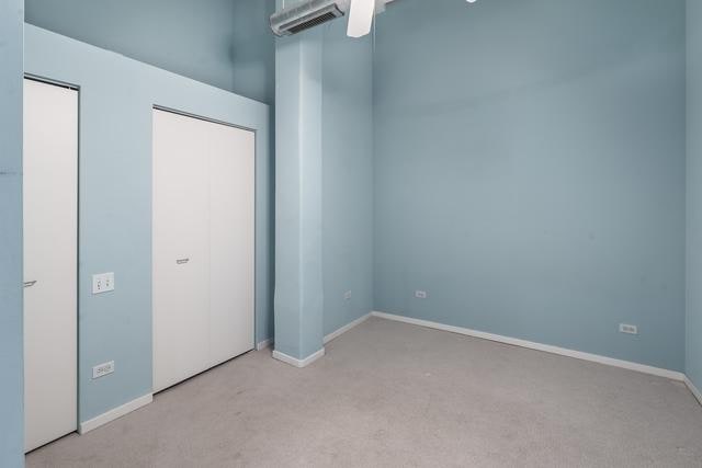 unfurnished bedroom with carpet flooring and baseboards