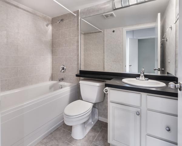 full bath featuring tile patterned flooring, toilet, visible vents, vanity, and shower / washtub combination