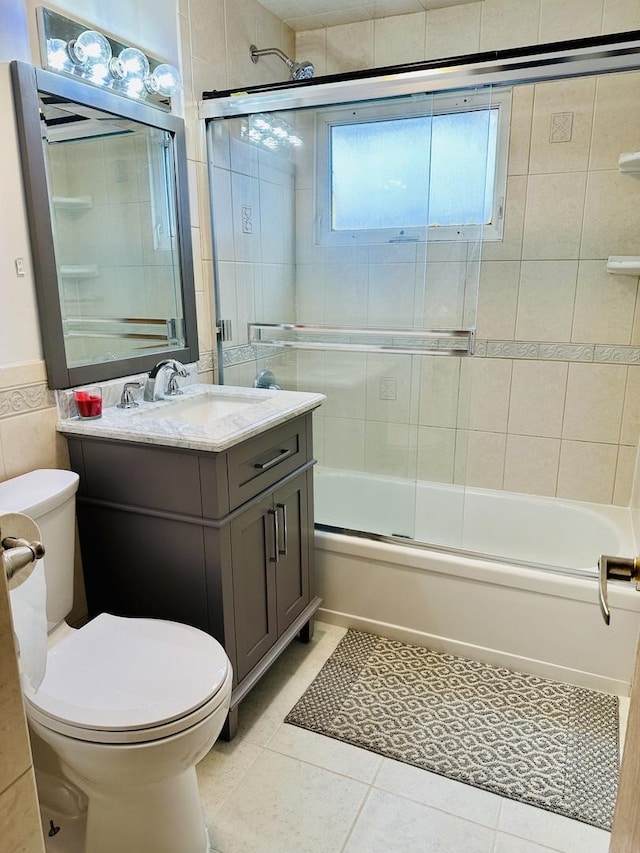 full bathroom with vanity, tile patterned floors, enclosed tub / shower combo, and toilet