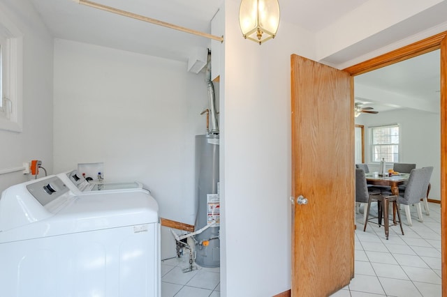 clothes washing area with washing machine and dryer, gas water heater, light tile patterned floors, and ceiling fan