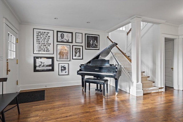 living area featuring ornamental molding, a wealth of natural light, dark wood-type flooring, and stairway