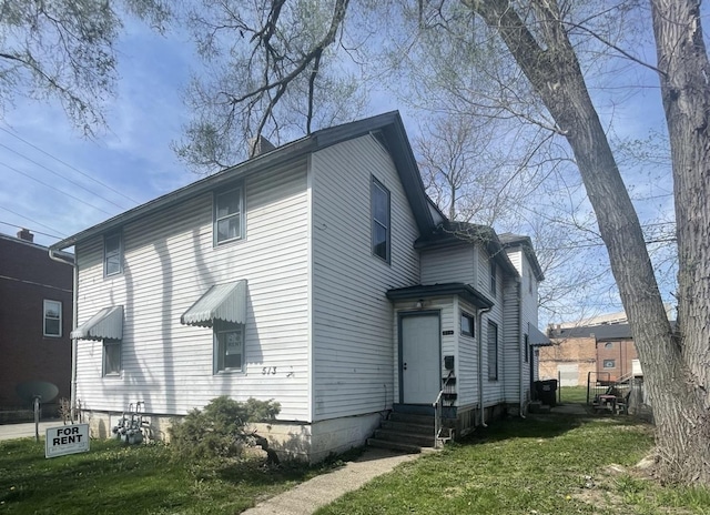 view of side of property with a yard