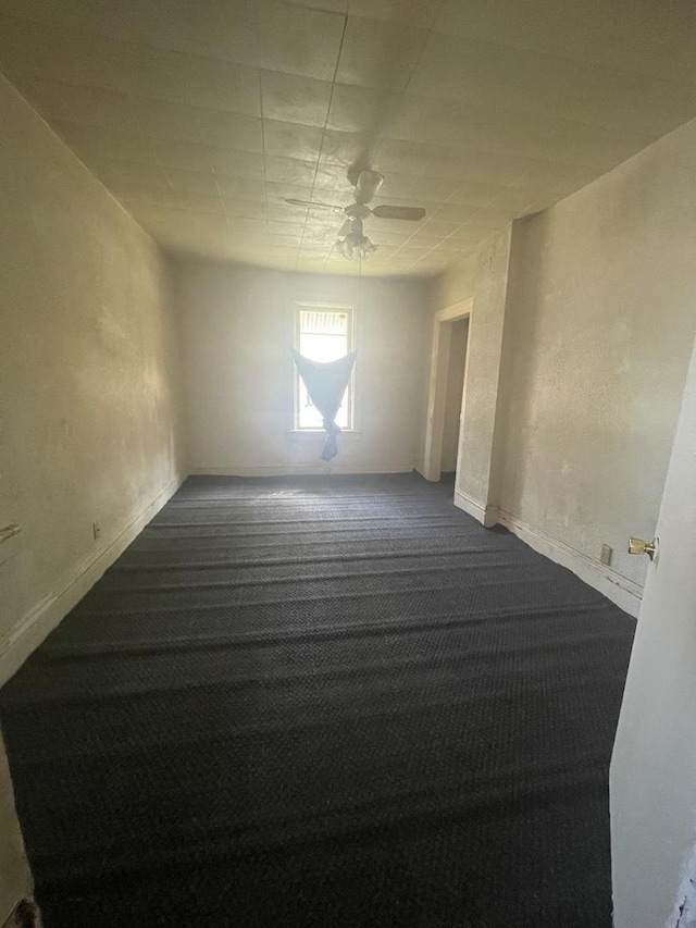 empty room with carpet floors and ceiling fan