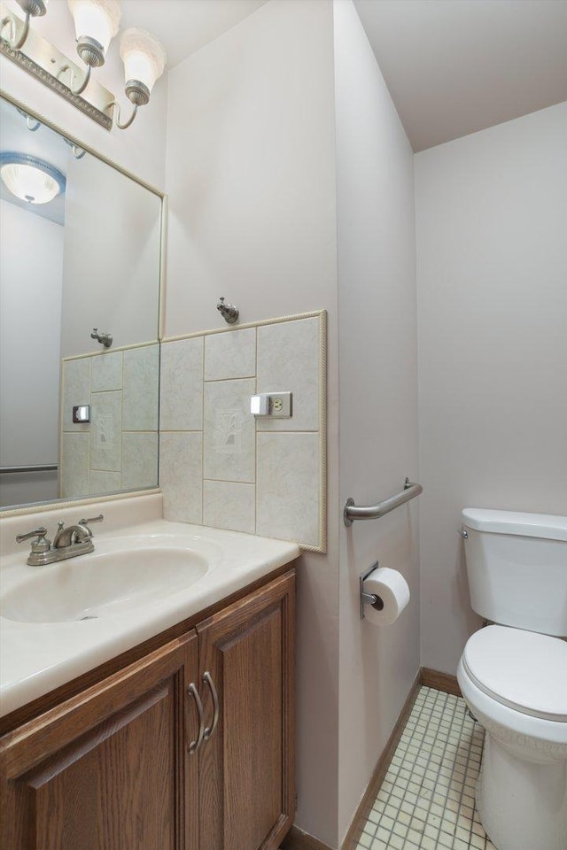 bathroom featuring vanity, tile patterned floors, and toilet