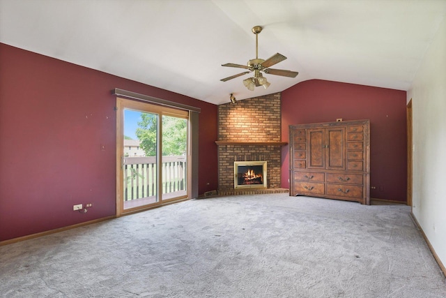 unfurnished living room featuring vaulted ceiling, a brick fireplace, light carpet, and ceiling fan