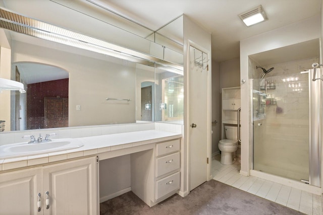 bathroom with vanity, toilet, and an enclosed shower