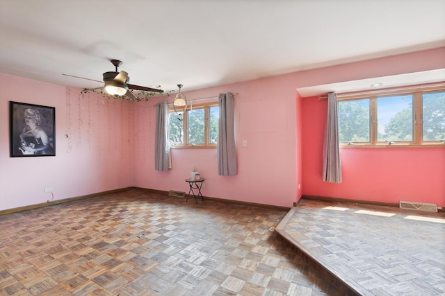 spare room featuring parquet flooring and ceiling fan