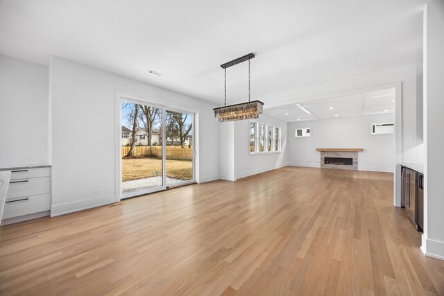 unfurnished living room with light hardwood / wood-style floors