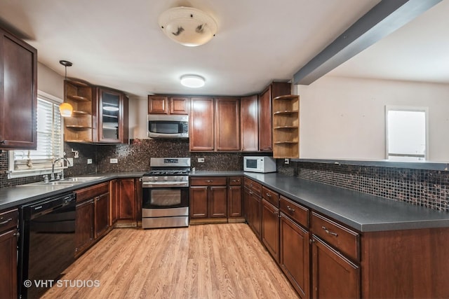 kitchen featuring pendant lighting, sink, light hardwood / wood-style flooring, stainless steel appliances, and decorative backsplash