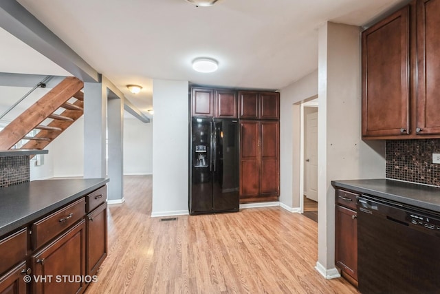 kitchen featuring backsplash, light hardwood / wood-style floors, and black appliances