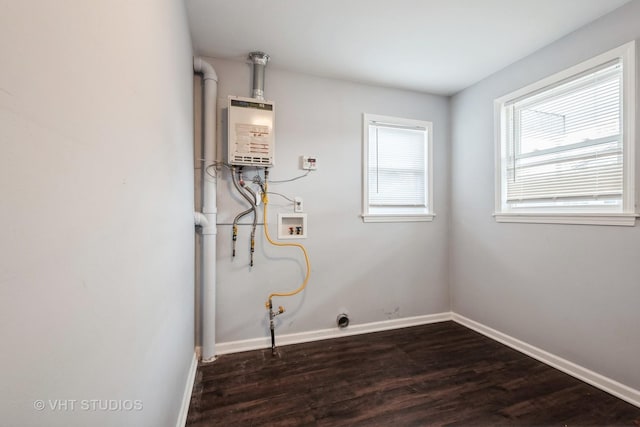 washroom with washer hookup, dark hardwood / wood-style flooring, and water heater