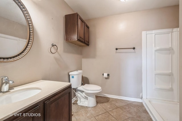 bathroom featuring tile patterned flooring, a shower, vanity, and toilet