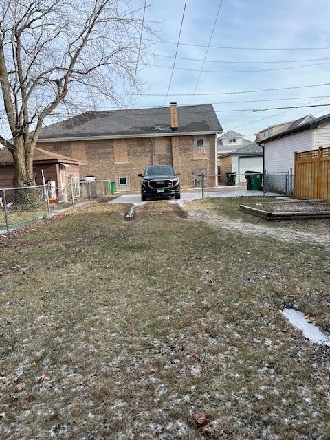 rear view of house featuring a lawn