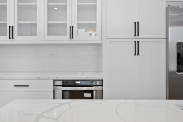 kitchen featuring light stone countertops and appliances with stainless steel finishes