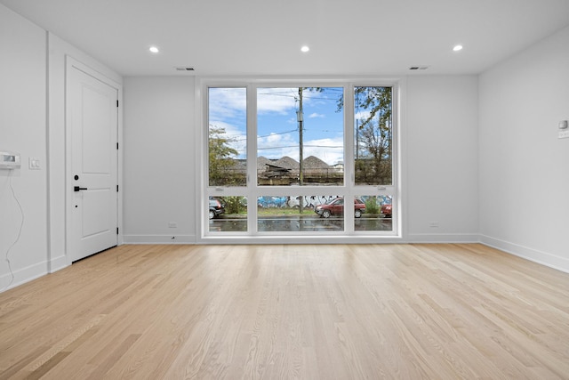 empty room with light hardwood / wood-style floors