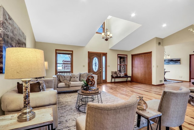 living room with a chandelier, baseboards, and wood finished floors