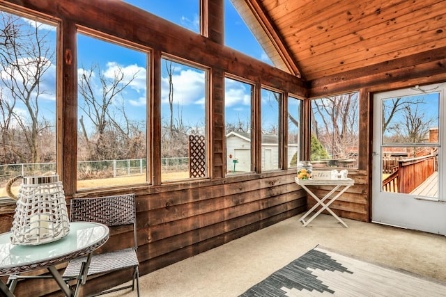 sunroom / solarium featuring wooden ceiling and vaulted ceiling