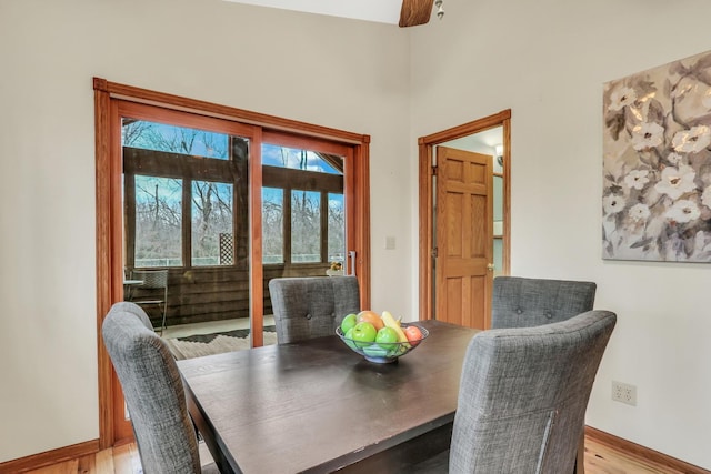 dining area featuring light wood-type flooring, ceiling fan, and baseboards