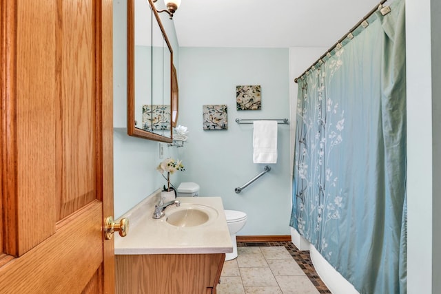 full bath with toilet, tile patterned flooring, baseboards, and vanity