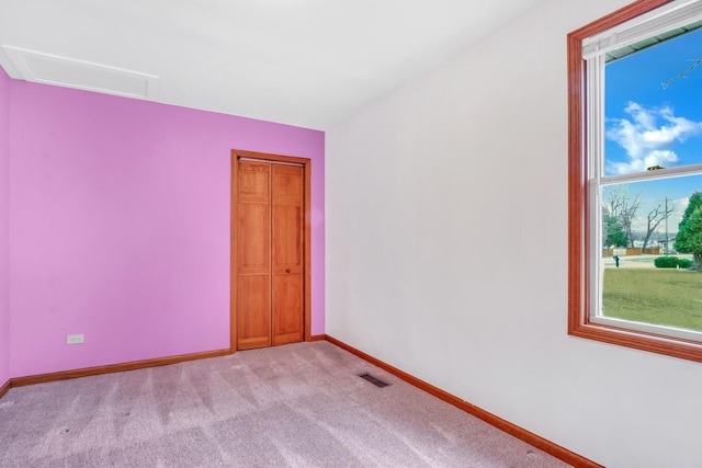 carpeted empty room with baseboards and visible vents