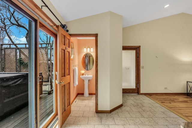 entryway featuring vaulted ceiling and baseboards