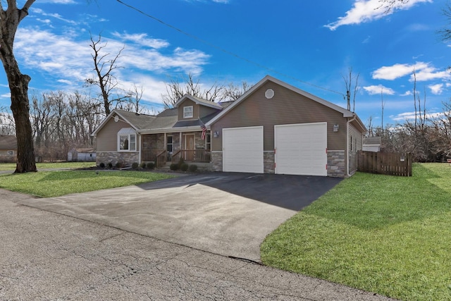 ranch-style house featuring a garage, driveway, stone siding, fence, and a front lawn