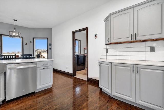 kitchen featuring tasteful backsplash, stainless steel dishwasher, dark hardwood / wood-style floors, a notable chandelier, and pendant lighting