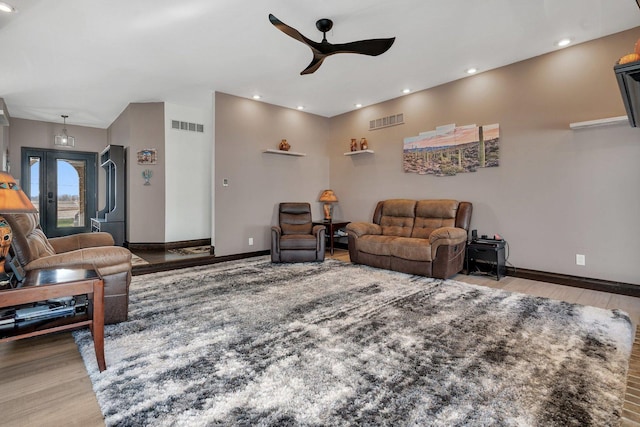 living room featuring ceiling fan and wood-type flooring