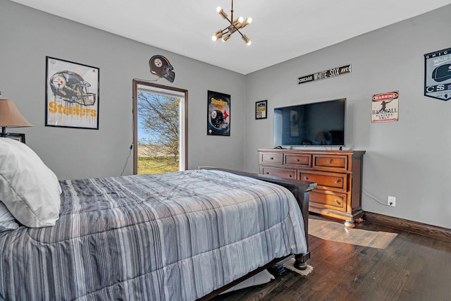 bedroom with dark wood-type flooring and a chandelier