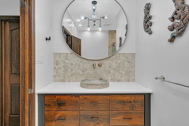 bathroom with vanity and tasteful backsplash