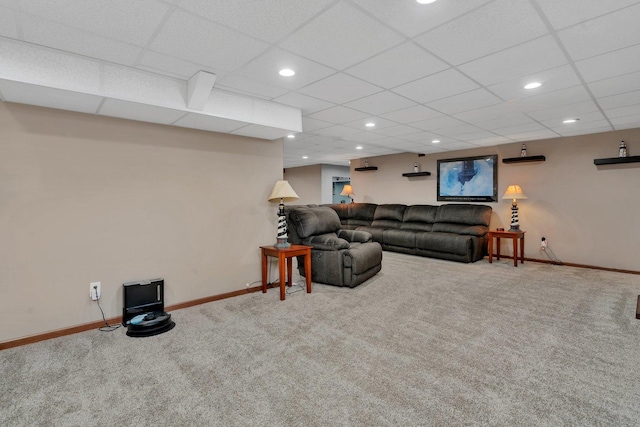 carpeted living room featuring a paneled ceiling