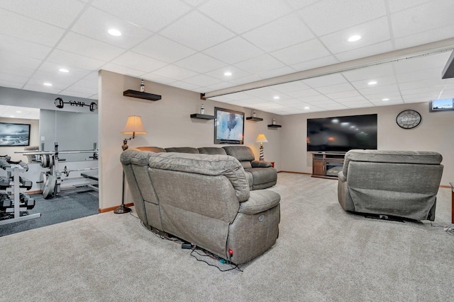 living room featuring carpet flooring and a drop ceiling