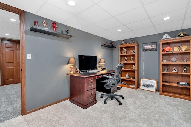 carpeted office space featuring a drop ceiling