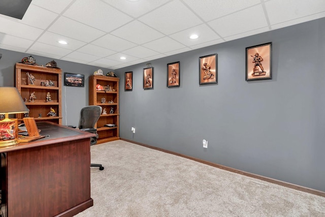 unfurnished office featuring light carpet and a drop ceiling