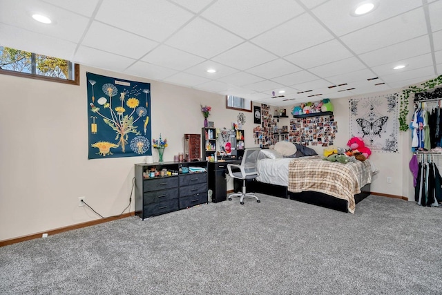 bedroom featuring a paneled ceiling and carpet flooring