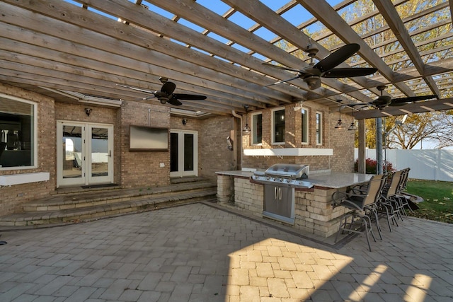 view of patio featuring an outdoor bar, a pergola, a mountain view, french doors, and an outdoor kitchen