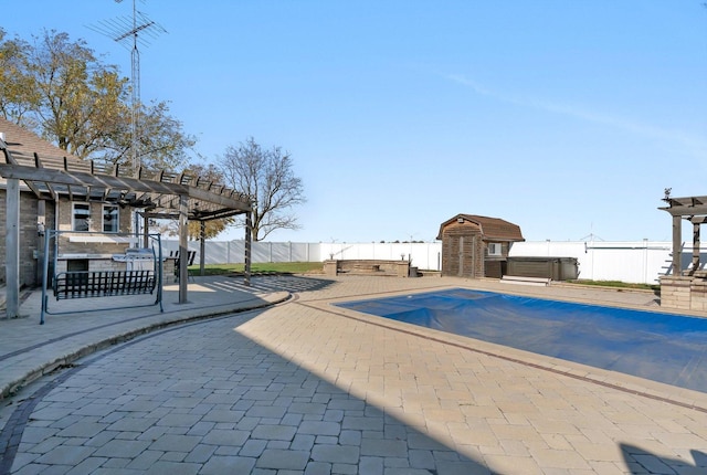 view of pool featuring a shed, a pergola, a patio area, and a hot tub