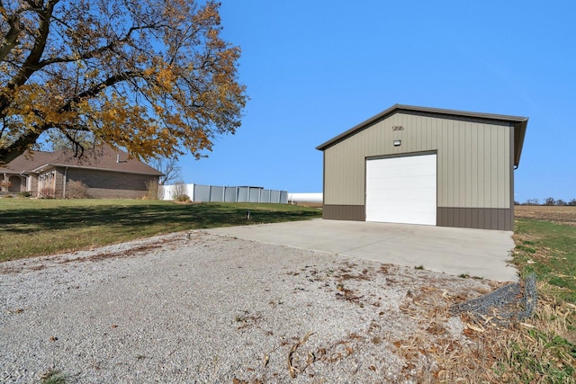 view of outbuilding with a garage and a lawn