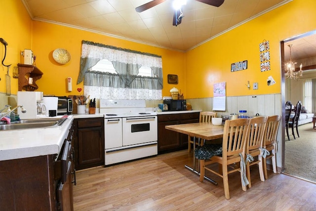 kitchen with range with two ovens, sink, dark brown cabinetry, and light hardwood / wood-style flooring