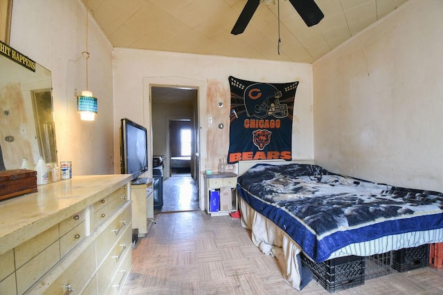 bedroom featuring ornamental molding, parquet floors, and ceiling fan