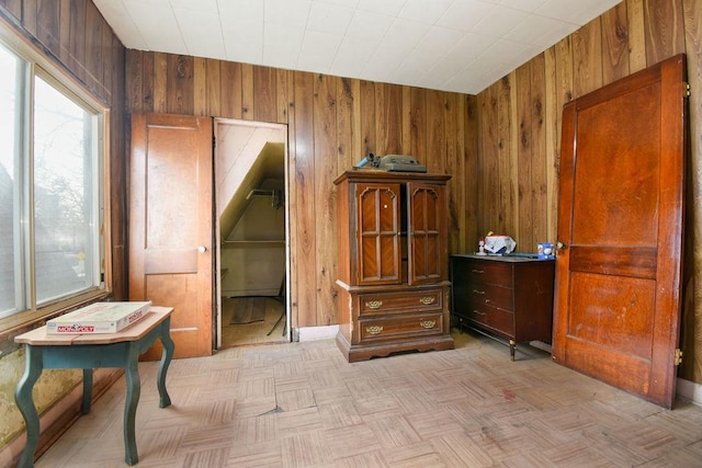 interior space featuring light parquet flooring and wooden walls