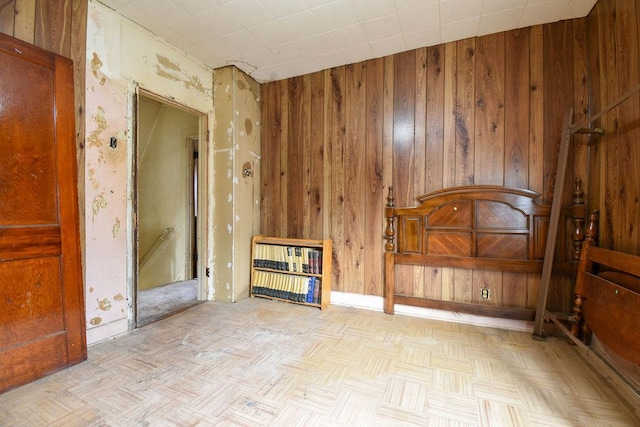 interior space featuring light parquet floors and wooden walls