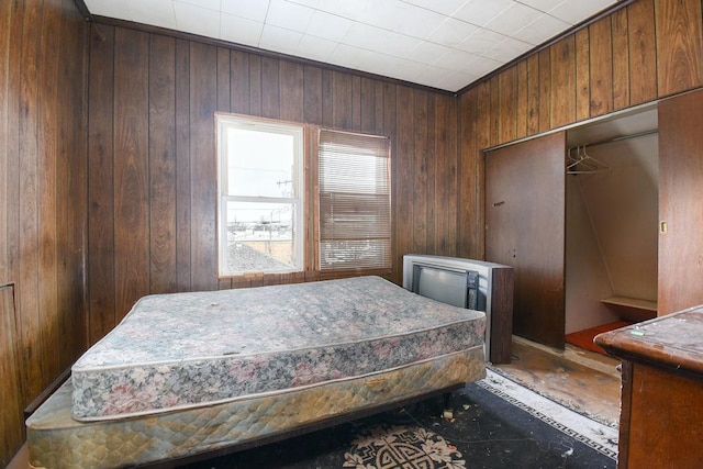 bedroom featuring wood walls